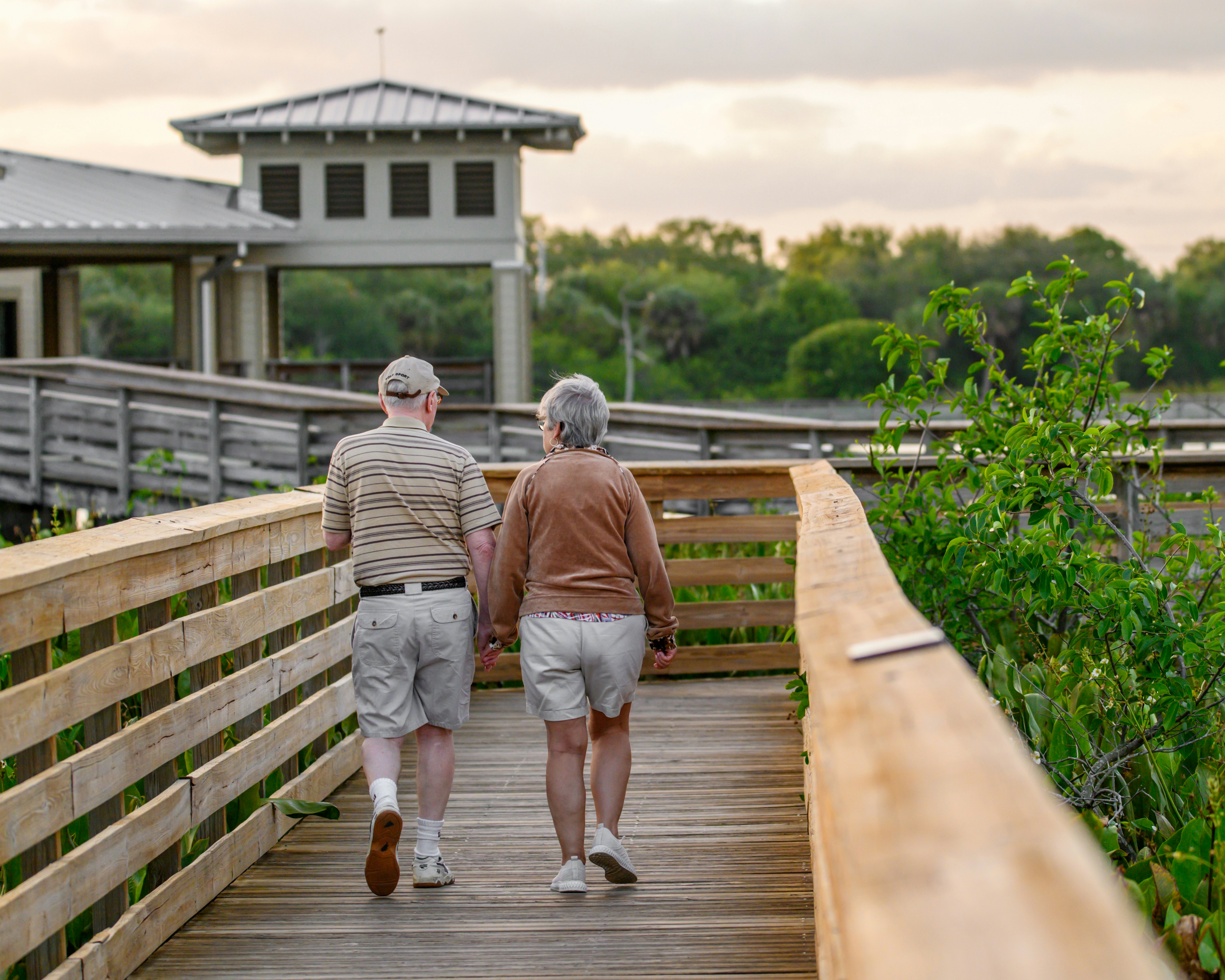 Senior couple walking along a Southwest Florida beach at sunset
